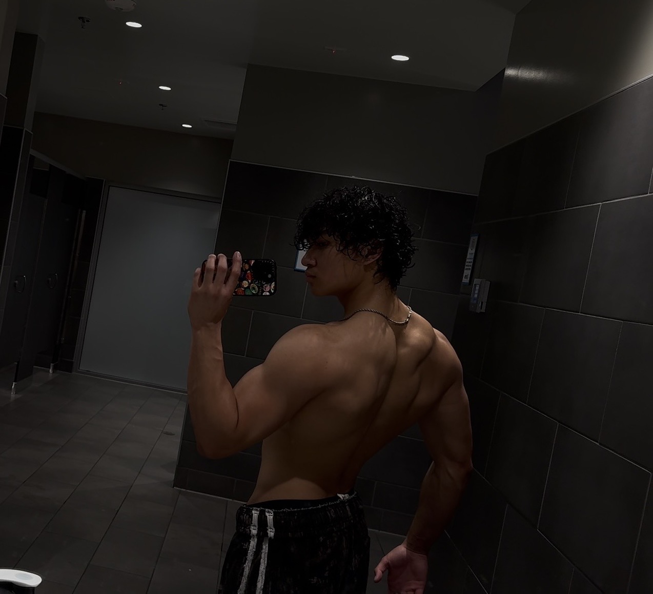 Early progress — mirror selfie showing back and shoulder development